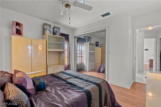 bedroom with ceiling fan, a closet, and light wood-type flooring