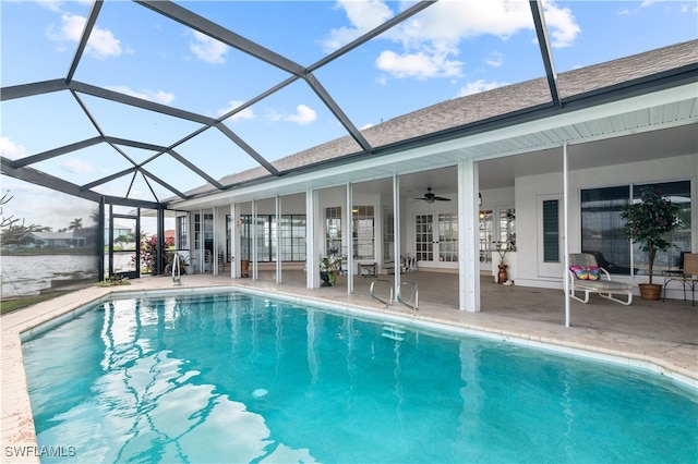 view of swimming pool featuring ceiling fan, a lanai, and a patio