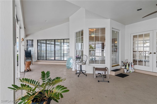 sunroom featuring vaulted ceiling and french doors