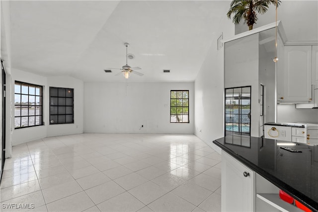 unfurnished living room with light tile patterned floors and ceiling fan