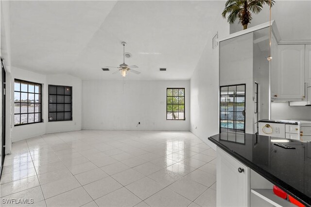 837 SW 2nd Ave, Cape Coral, FL 33991 - unfurnished living room featuring a ceiling fan, lofted ceiling, and light tile patterned floors