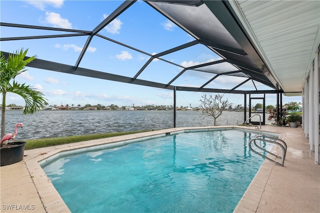 view of pool with a water view, glass enclosure, and a patio area