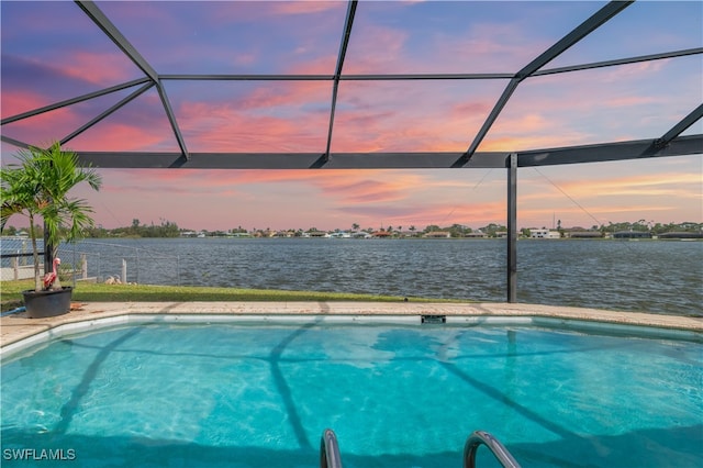 pool at dusk with glass enclosure and a water view