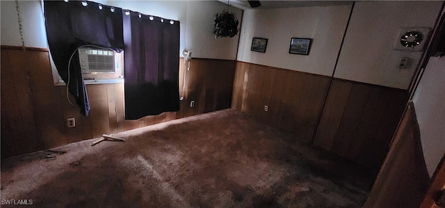 interior space with wood walls and ceiling fan