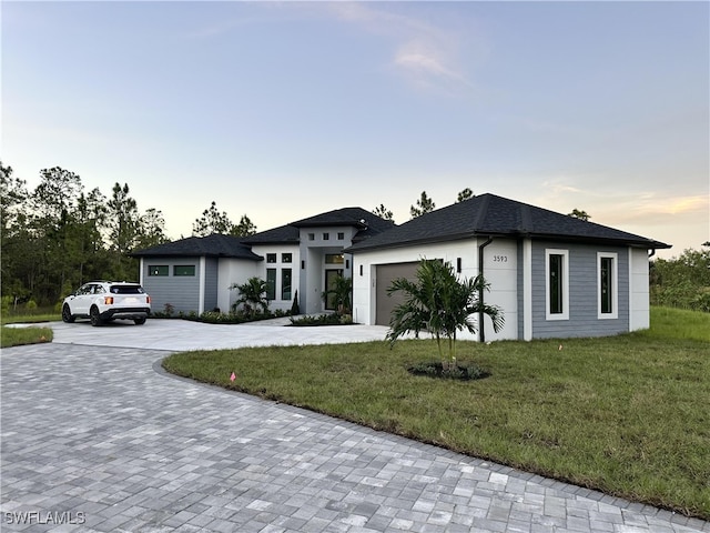 view of front of house with a lawn and a garage