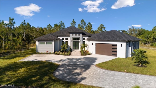 view of front of home with a front yard and a garage