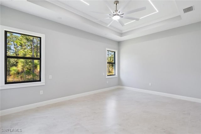 unfurnished room with a tray ceiling and ceiling fan