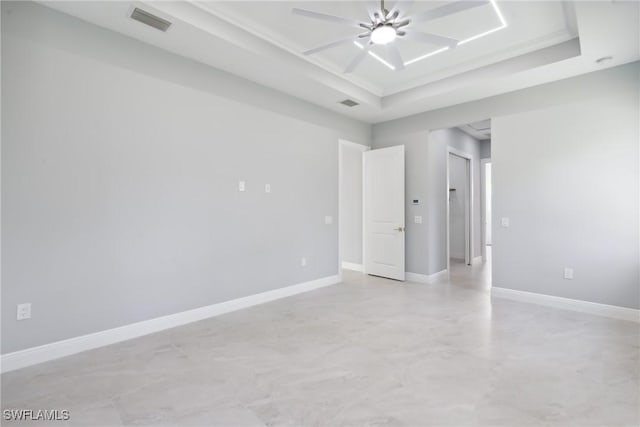 unfurnished room with a raised ceiling and ceiling fan