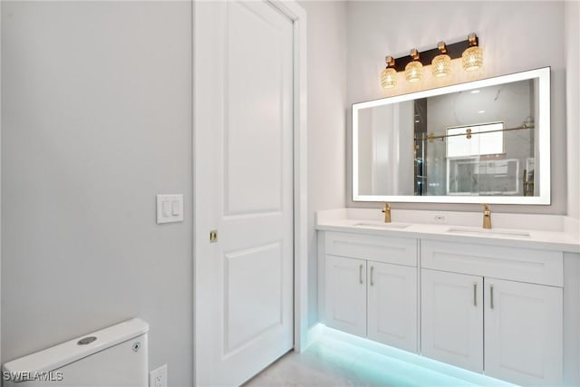 bathroom featuring vanity, an enclosed shower, and toilet