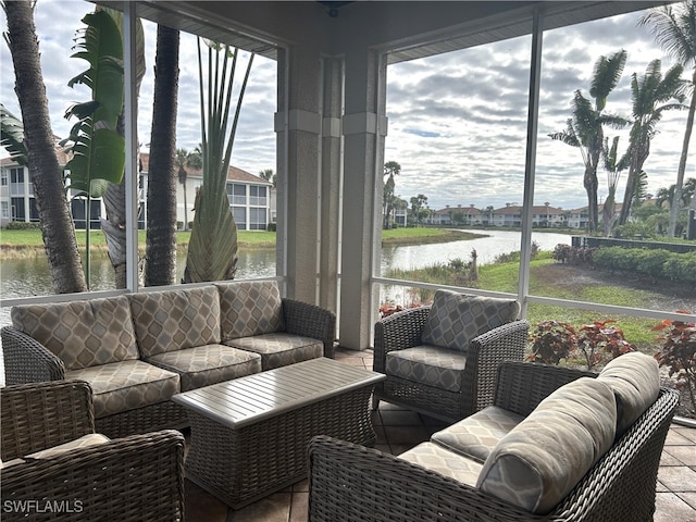 sunroom / solarium featuring a water view and a wealth of natural light