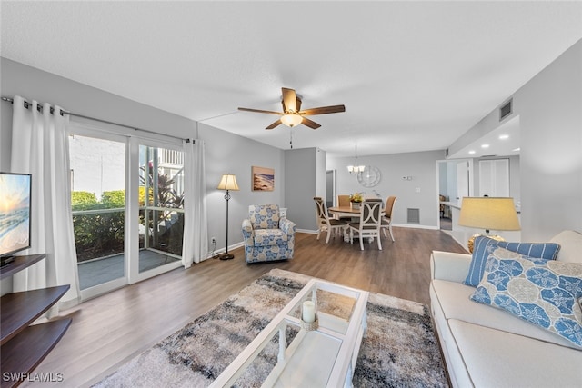 living room with ceiling fan and hardwood / wood-style floors