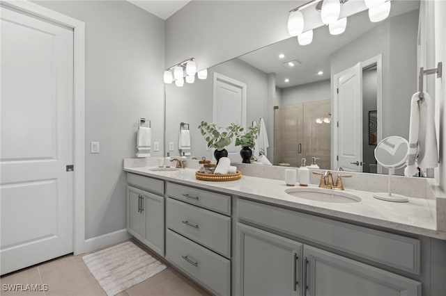 bathroom with vanity, walk in shower, and tile patterned flooring