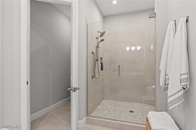 bathroom featuring tile patterned floors and a shower with door