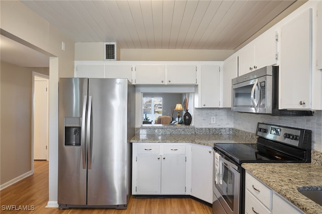 kitchen featuring decorative backsplash, appliances with stainless steel finishes, light wood-type flooring, light stone counters, and white cabinets