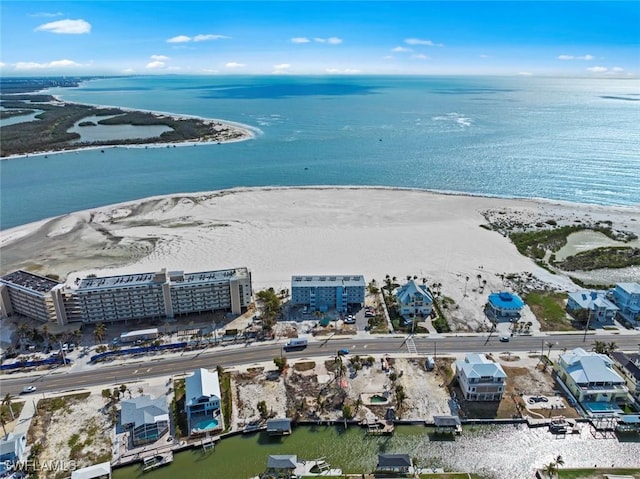 birds eye view of property featuring a beach view and a water view