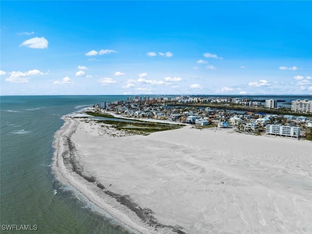 drone / aerial view with a water view and a beach view