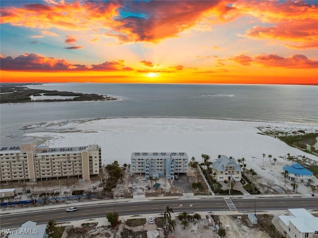 aerial view at dusk featuring a water view