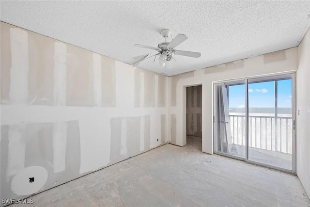 spare room with a textured ceiling and ceiling fan