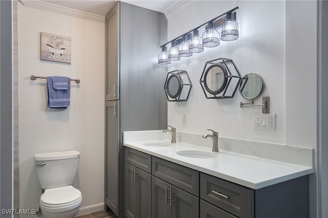 bathroom featuring vanity, toilet, and ornamental molding