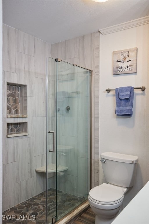 bathroom with an enclosed shower and toilet