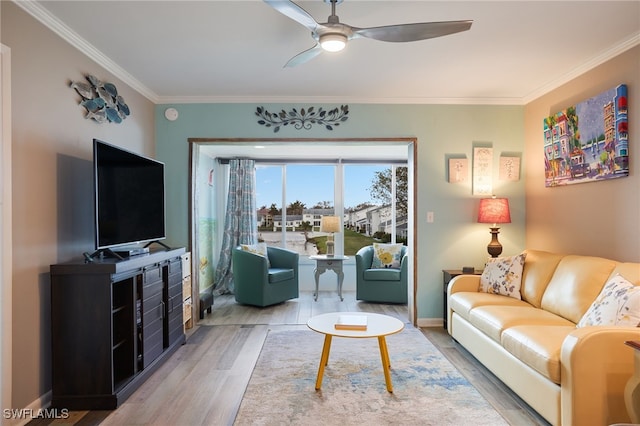 living room with hardwood / wood-style flooring, ceiling fan, and crown molding