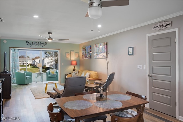 dining area featuring ceiling fan, light wood-type flooring, and ornamental molding