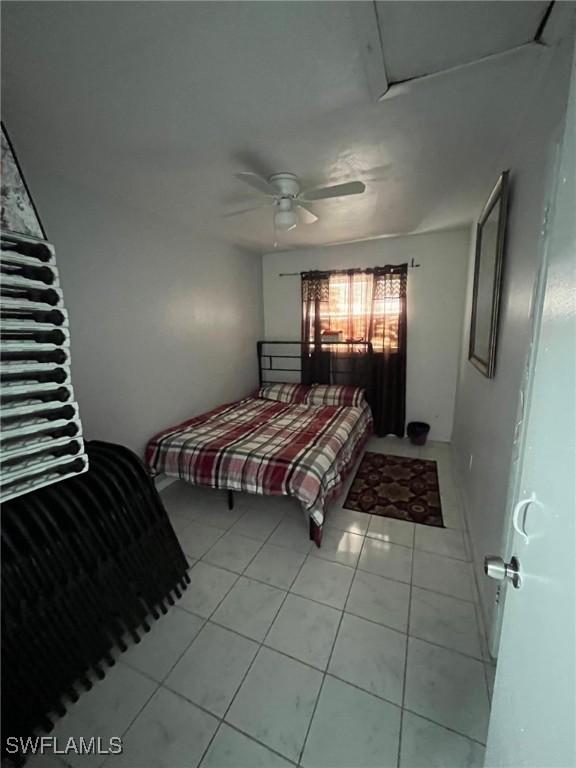 bedroom with ceiling fan and light tile patterned flooring