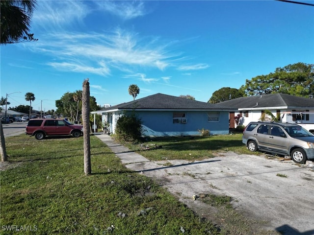 view of side of home with a lawn