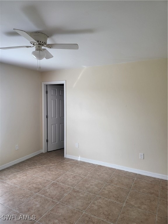 spare room with light tile patterned flooring and ceiling fan