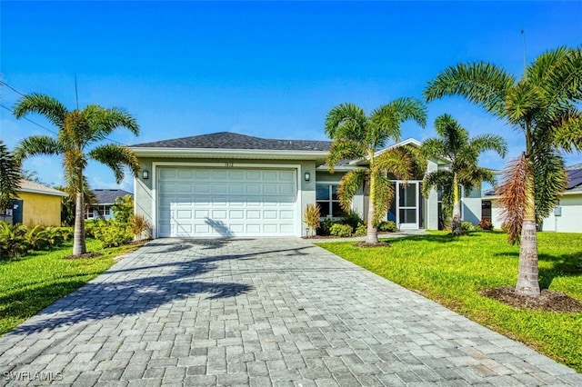 single story home featuring a garage and a front lawn