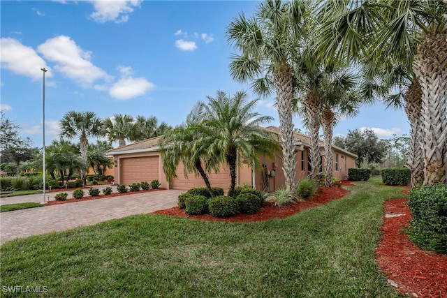 view of front of house with a garage and a front yard