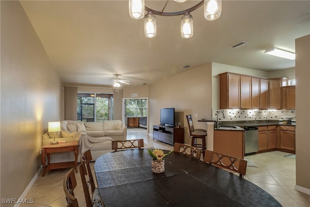 tiled dining space with sink and ceiling fan