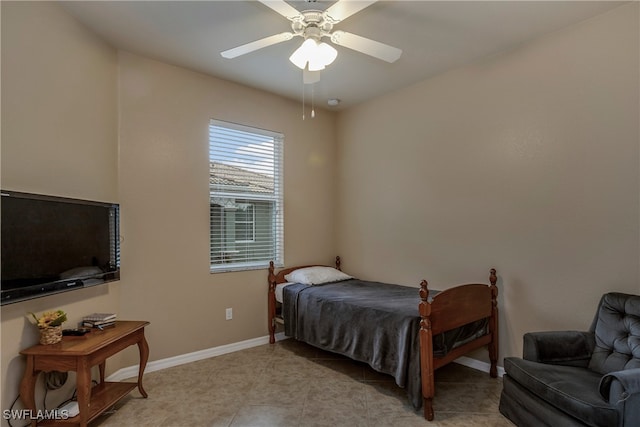 bedroom featuring a ceiling fan, baseboards, and light tile patterned floors