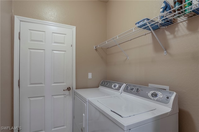 clothes washing area featuring laundry area and washer and dryer