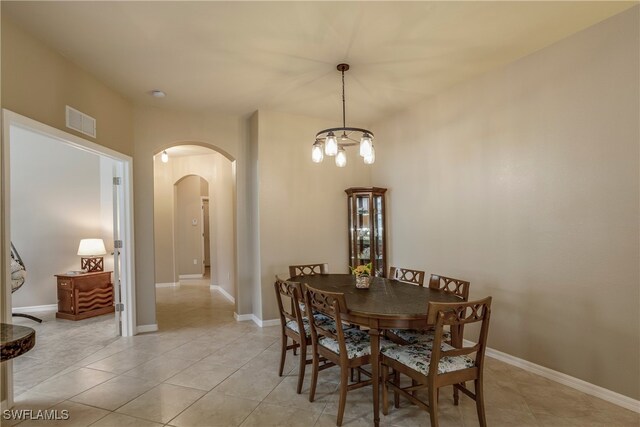 dining area featuring a notable chandelier and light tile patterned floors