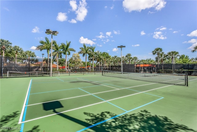 view of sport court featuring fence