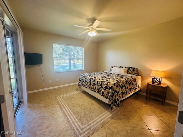 tiled bedroom featuring ceiling fan