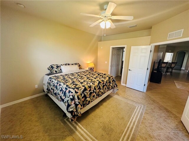 bedroom with ceiling fan and tile patterned flooring