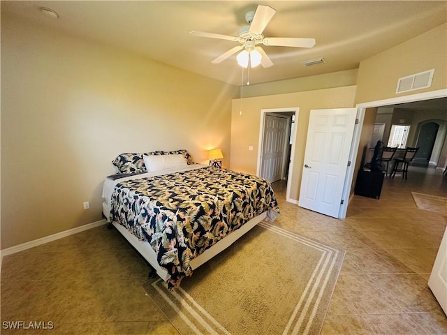 bedroom with ceiling fan, baseboards, visible vents, and arched walkways