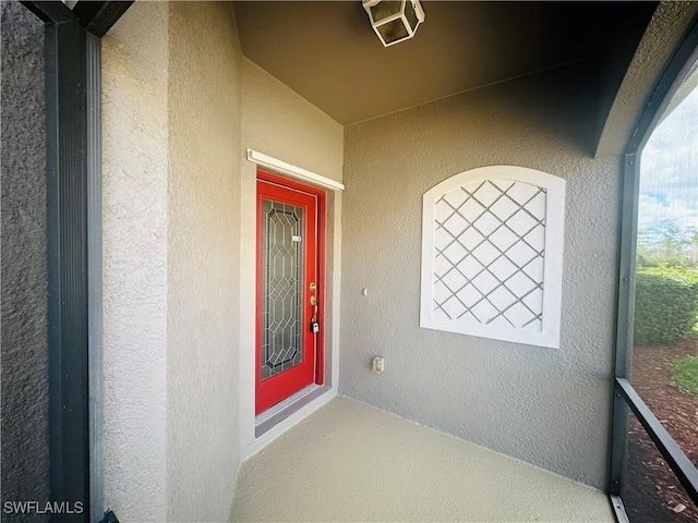 view of exterior entry featuring stucco siding