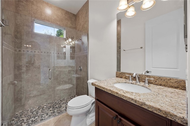 bathroom with vanity, walk in shower, tile patterned flooring, and toilet