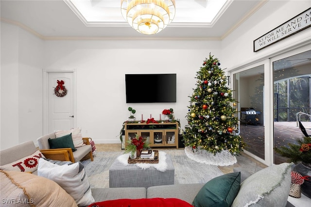 living room with a notable chandelier and crown molding