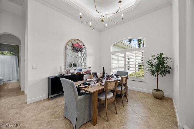 tiled dining area featuring ornamental molding and a chandelier