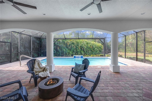 view of pool featuring a patio area, a lanai, ceiling fan, and pool water feature