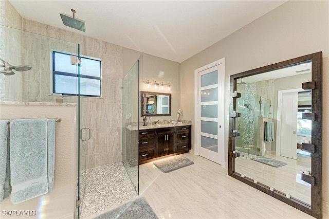 bathroom featuring vanity and an enclosed shower