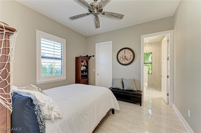 bedroom with ensuite bathroom and ceiling fan