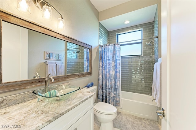 full bathroom featuring toilet, vanity, and shower / bath combo with shower curtain