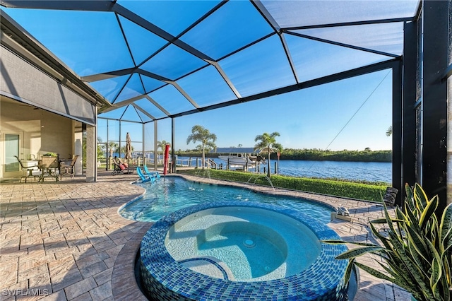 view of swimming pool featuring a water view, glass enclosure, a patio, and an in ground hot tub