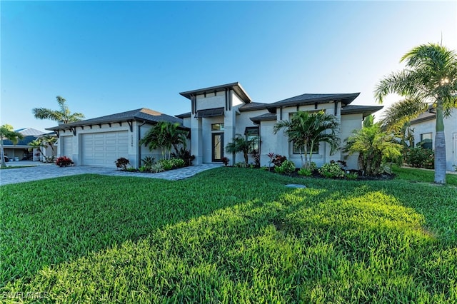 view of front of house featuring a garage and a front lawn