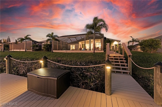 deck at dusk featuring a lanai